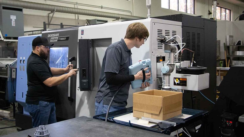 Man programming a collaborative robot