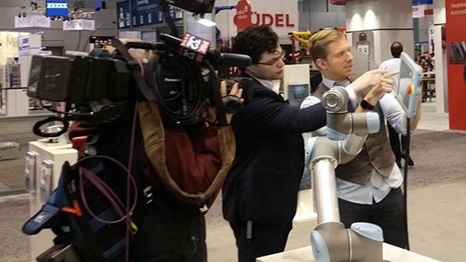 robots available show attendees how they simply grab a robot arm and teach it a move