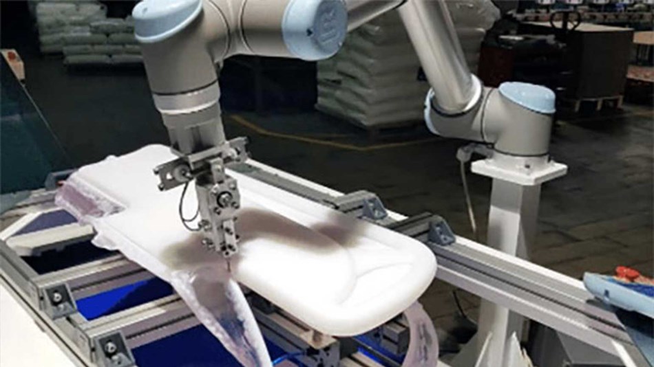 A UR cobot cuts a blow-molded part for a hospital bed