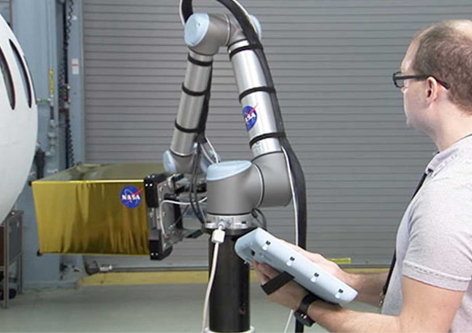 Mittels eines thermographischen Verfahrens überprüft der Cobot die Oberfläche eines Raketenrumpfes auf Auffälligkeiten und Defekte.